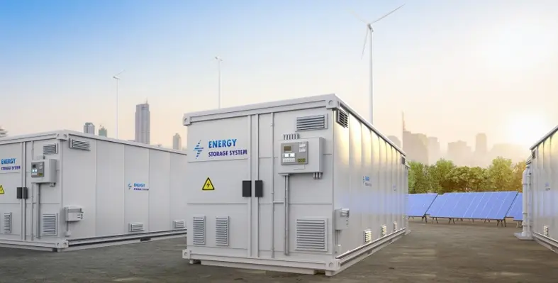An image of an energy storage system in front of wind turbines and a skyline. 