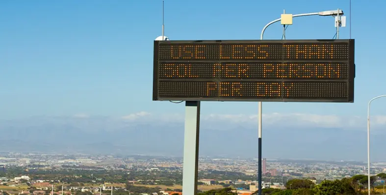 An electronic road sign reading use less than 50L per person per day.