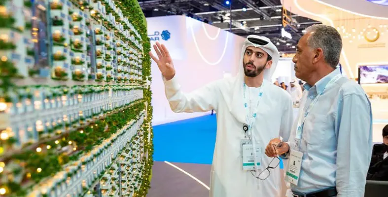Two people inspecting new technology at a conference.