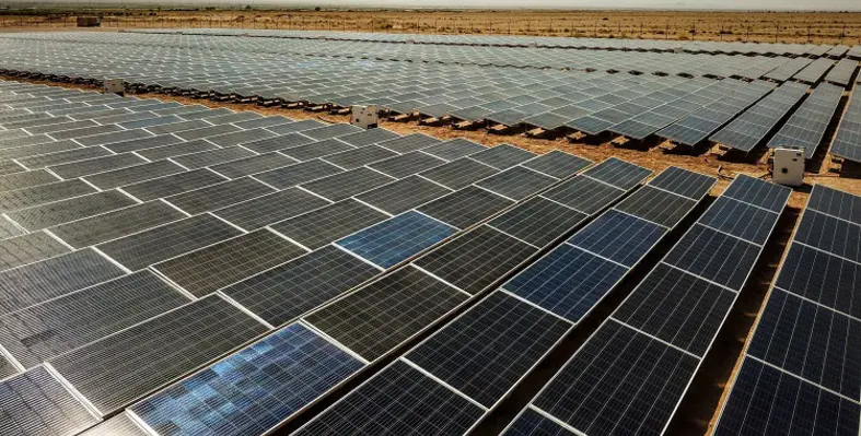 An overhead shot of a solar farm with hundreds of panels. 