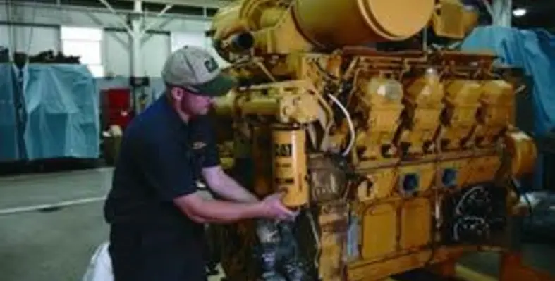 Caterpillar_technician_servicing_a_Cat_3508_marine_engine